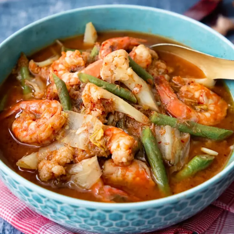 Delicious Gaeng Som, a Thai sour curry featuring shrimp and vibrant spices.