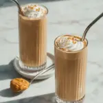 Delicious Coconut Coffee Smoothie in a glass with coconut and coffee beans