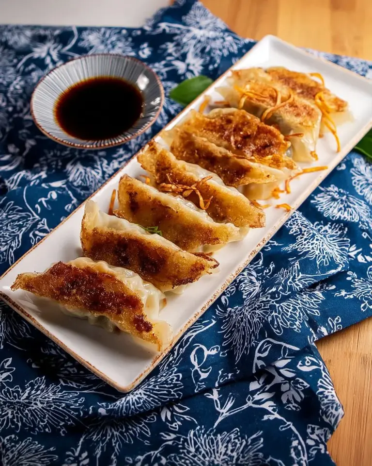 Plate of juicy umami dumplings garnished with herbs