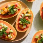 Delicious Papaya Lime Boats filled with fresh fruit and lime juice.