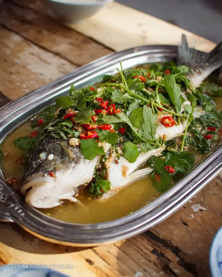 Steamed fish with lime garlic sauce served on a plate