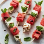 Watermelon feta mint skewers on a platter, perfect summer appetizer.