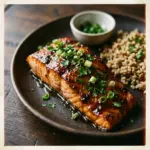 Honey garlic glazed salmon on a plate with vegetables