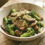 A plate of beef and broccoli stir-fry with vibrant vegetables and savory sauce.