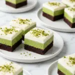 Green velvet brownies with cream cheese frosting on a plate